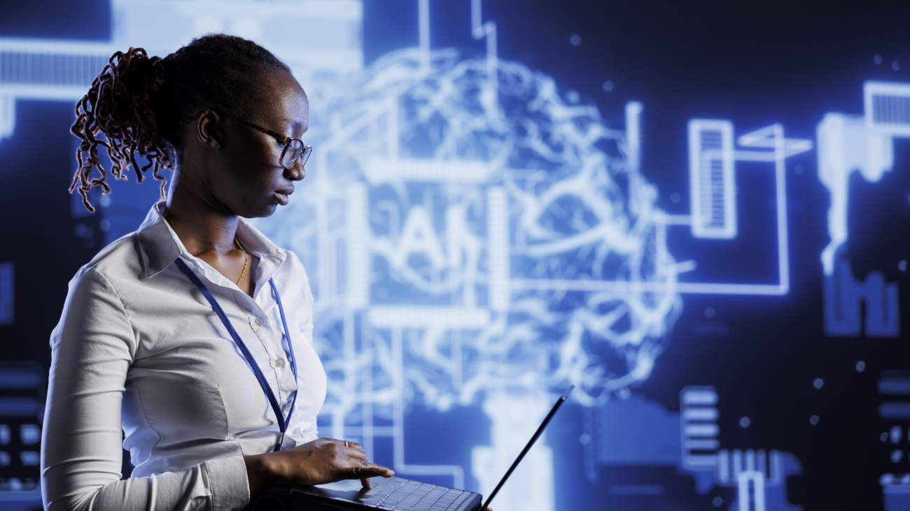 Tech support uses laptop to develop artificial intelligence neural networks nodes modeled after human brain. Data center worker setting up AI machine learning accurately making predictions using data