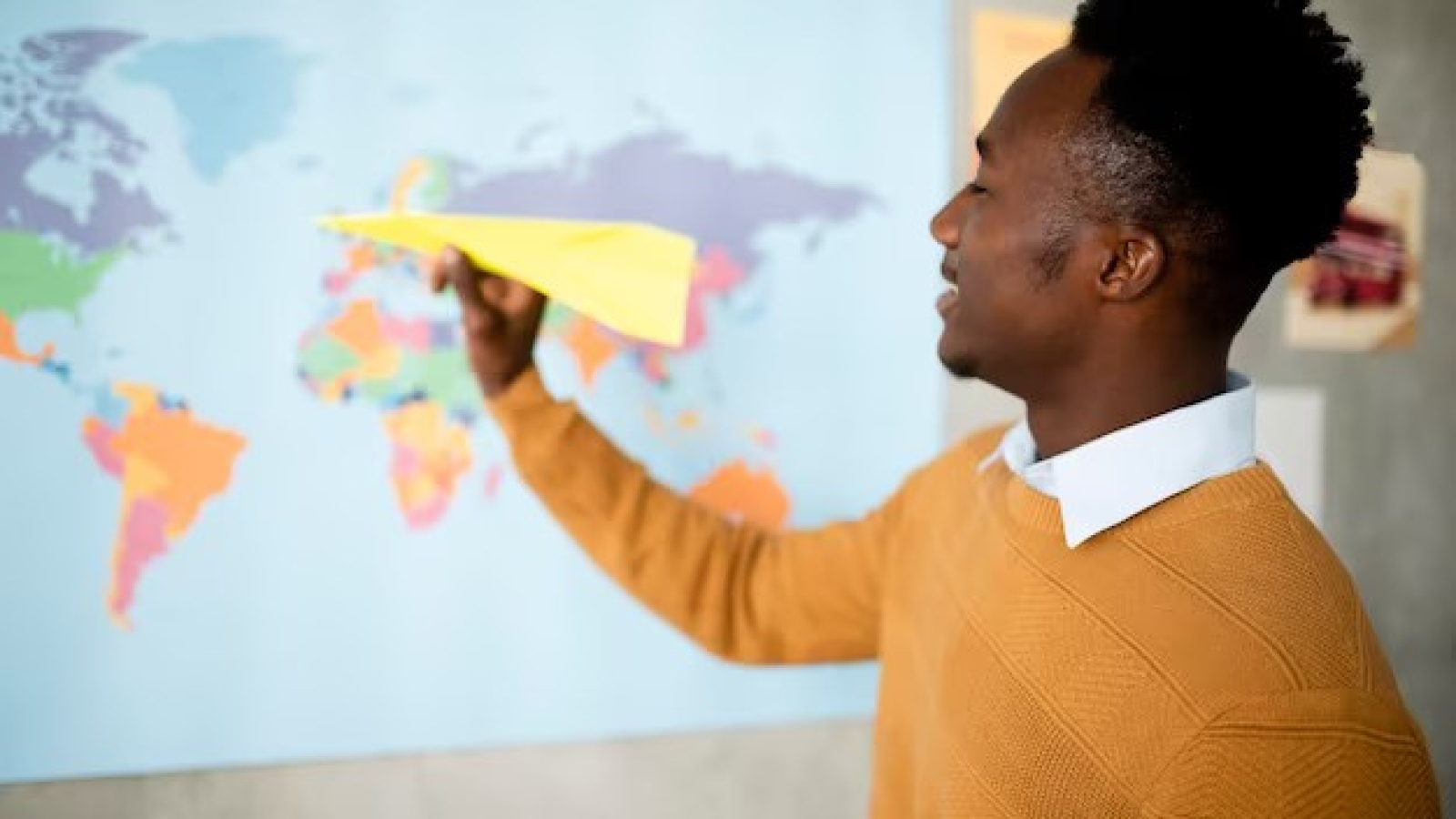 medium-shot-man-holding-paper-plane_23-2149080802
